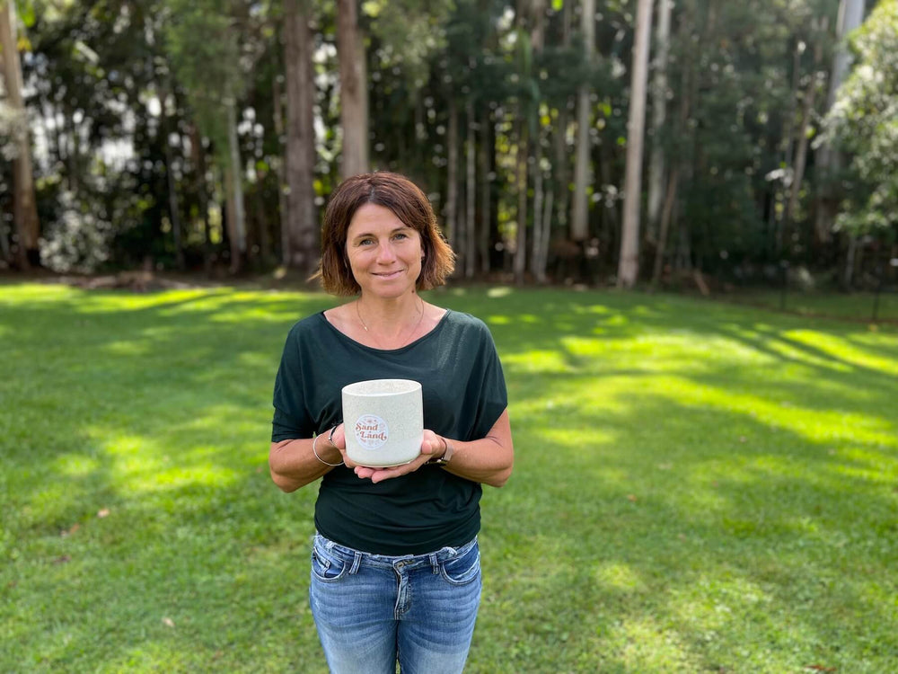 Sand and Land Creator Maree Ratcliffe in her element with an outdoor candle