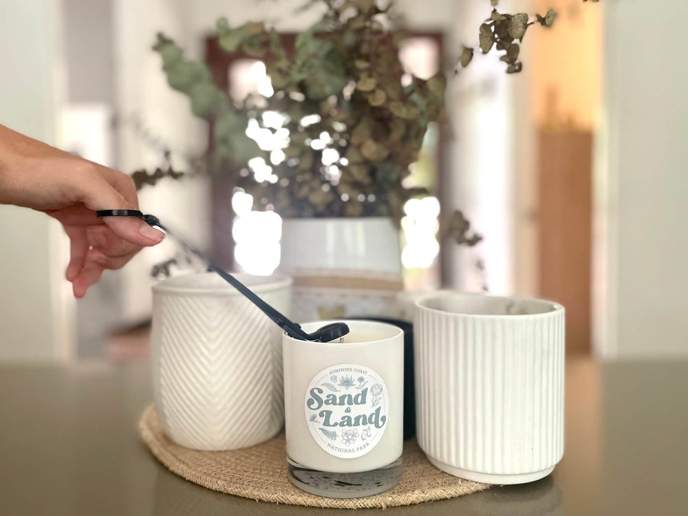 Sand and Land Candle with Wick being trimmed